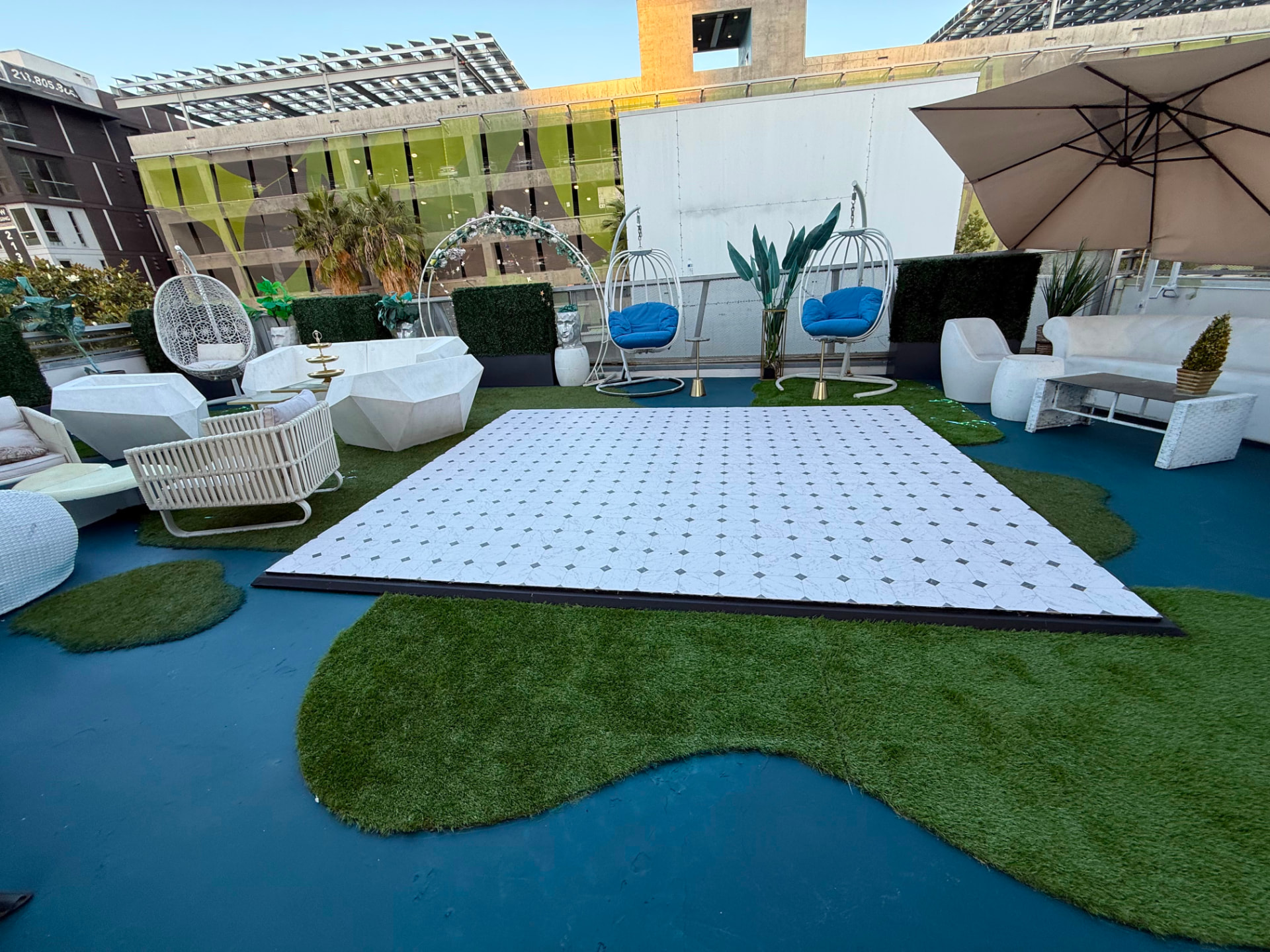 The rooftop marble dance floor and white lounge furniture in daylight